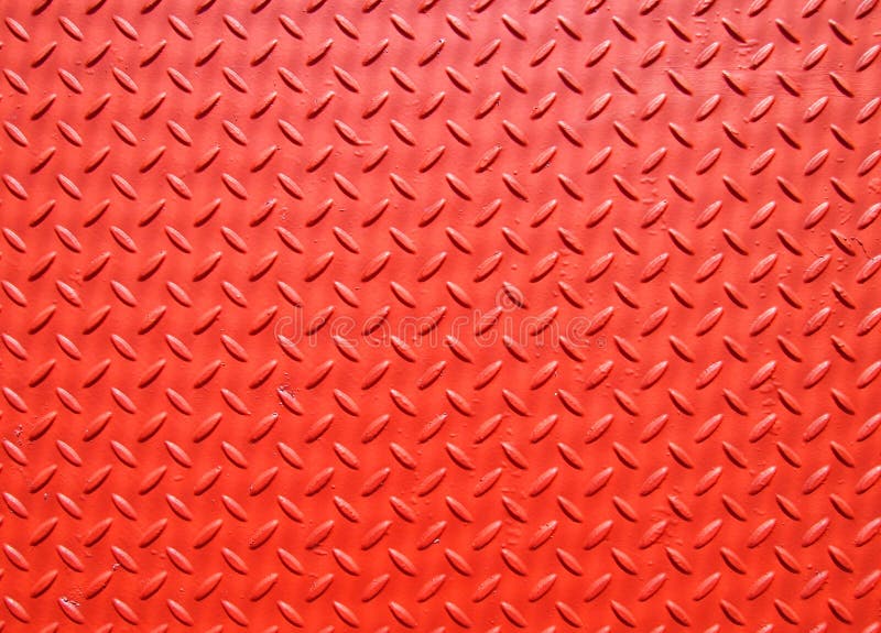 Red painted industrial metal plate industrial diamond pattern grip texture stock photo